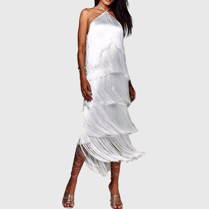 A trendy women's cocktail party dress, highlighting a halter neck, open back, and glamorous tassels.