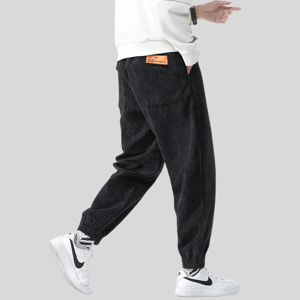 Comfortable men's wide-leg corduroy joggers. Relaxed fit design ideal for everyday casual wear in gray or black.