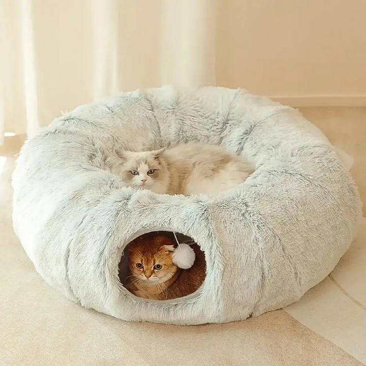 Gray plush cat tunnel bed with dangling toy ball, offering a cozy indoor playground for cats.