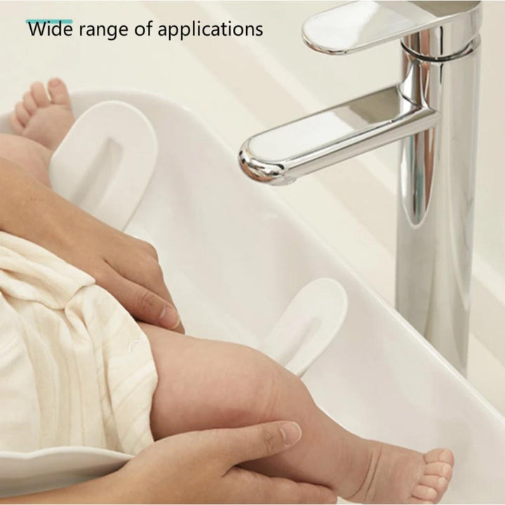 Toddler using a white baby bath seat, demonstrating ease of use and secure bathing support.