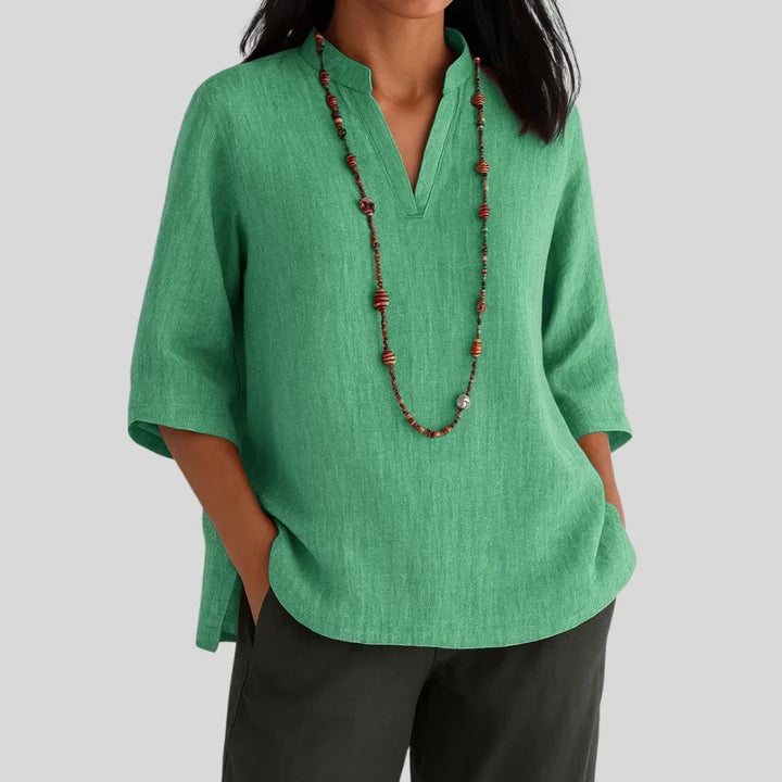 Green women's relaxed V-neck blouse with 3/4 sleeves and stylish side slits, perfect for casual summer elegance.