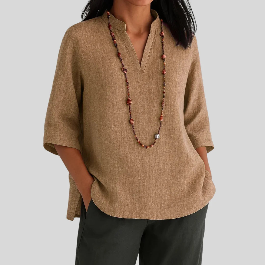 Brown women's relaxed fit 3/4-sleeve V-neck blouse with side slits, offering comfort and casual elegance.