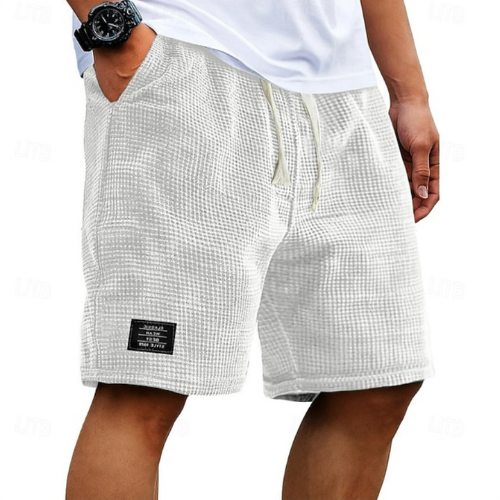 Close-up of breathable fabric on men's casual summer shorts, highlighting the comfortable, lightweight texture.