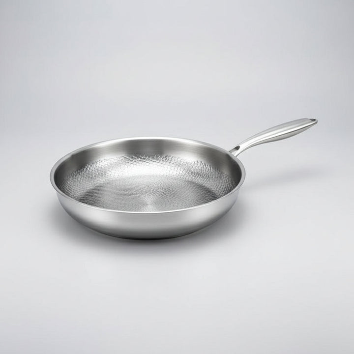 Modern hammered titanium frying pan, perfect for induction. Enhances any kitchen cooking.