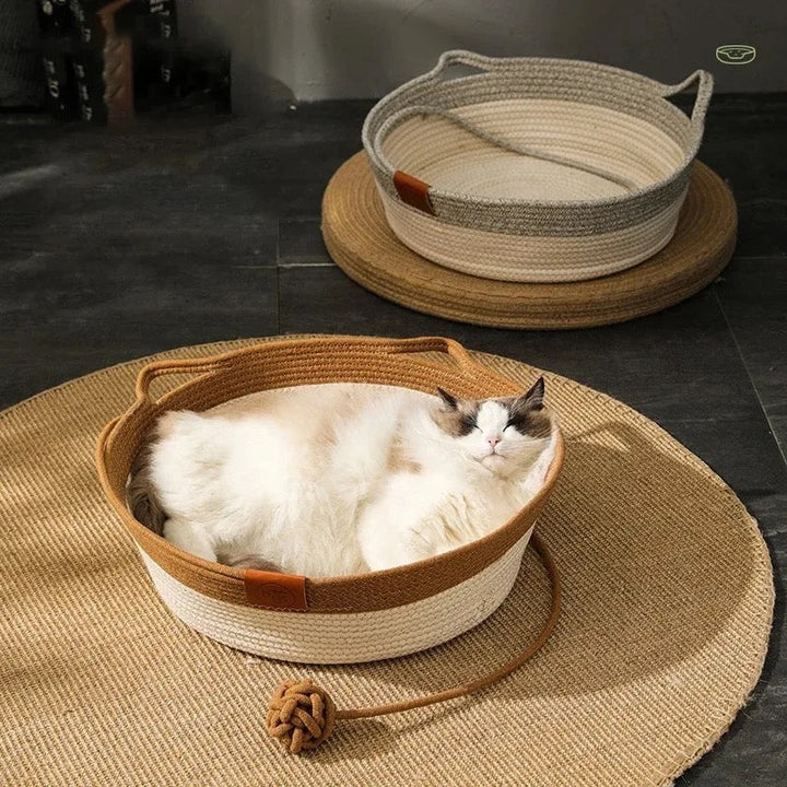 Hand-woven cotton rope cat bed, perfect for scratching and lounging indoors.