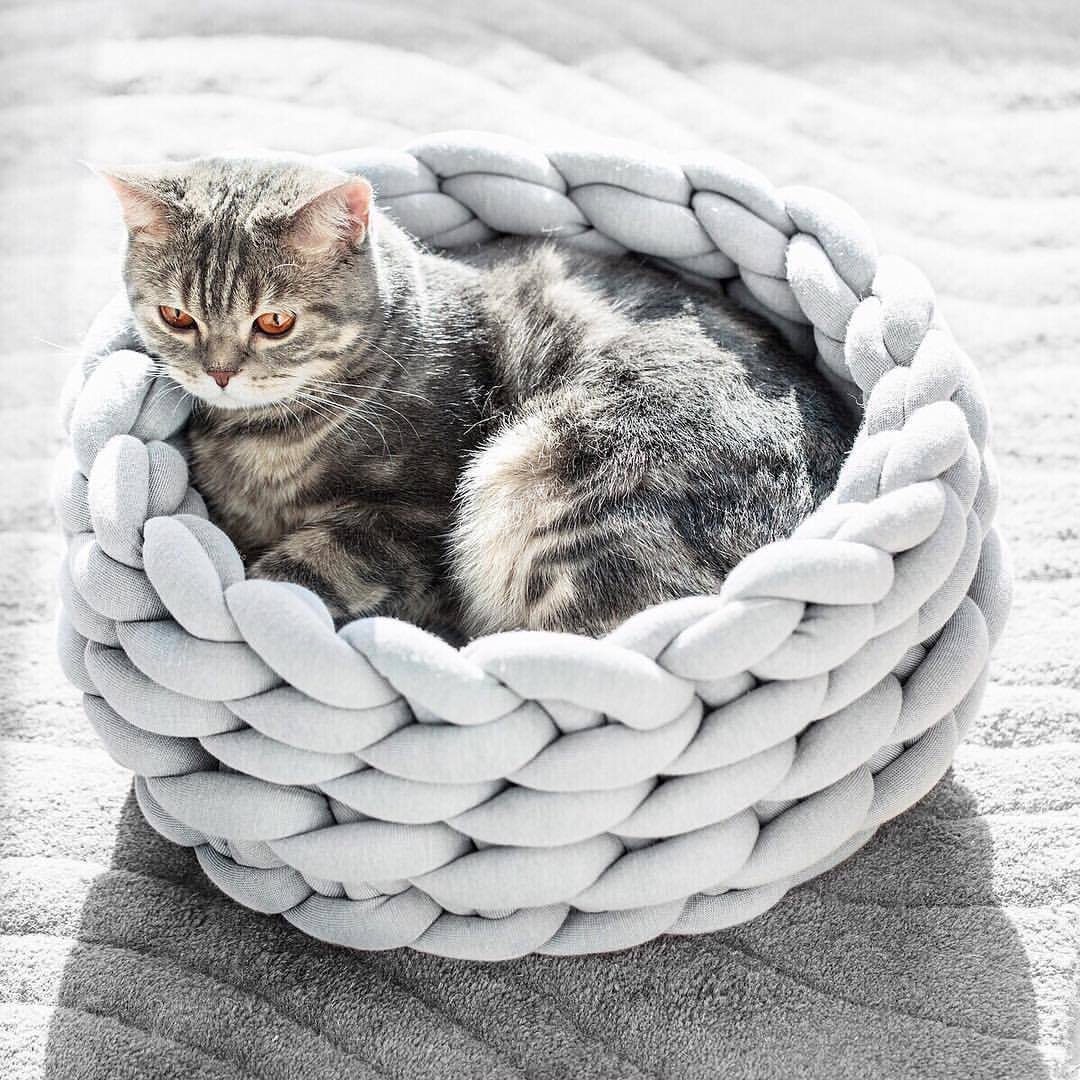 Hand-woven grey cat bed basket providing a cozy and stylish pet retreat.