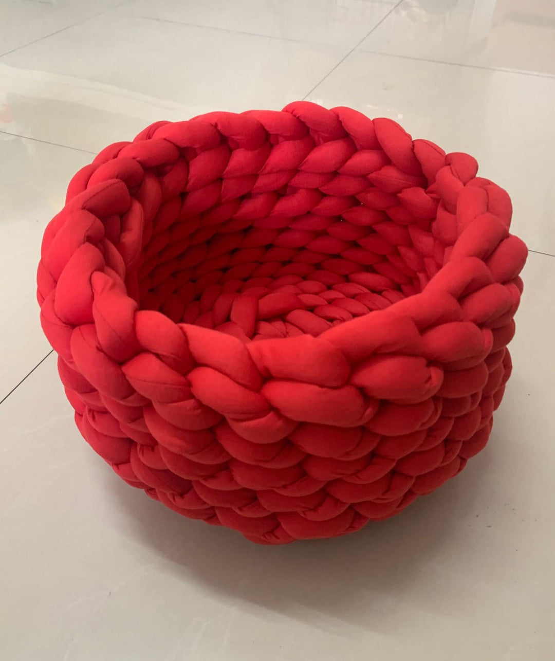 Round, hand-woven cat bed made from natural materials for ultimate comfort.