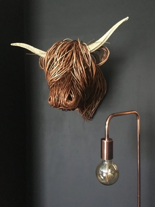 Hand-woven rattan Toro wall sculpture. Rustic, natural fiber art for modern farmhouse or boho home decor.