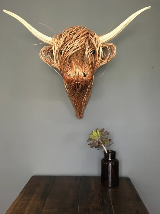 Striking Toro wall sculpture. Hand-woven rattan art adds a unique, rustic touch to modern farmhouse & boho homes.