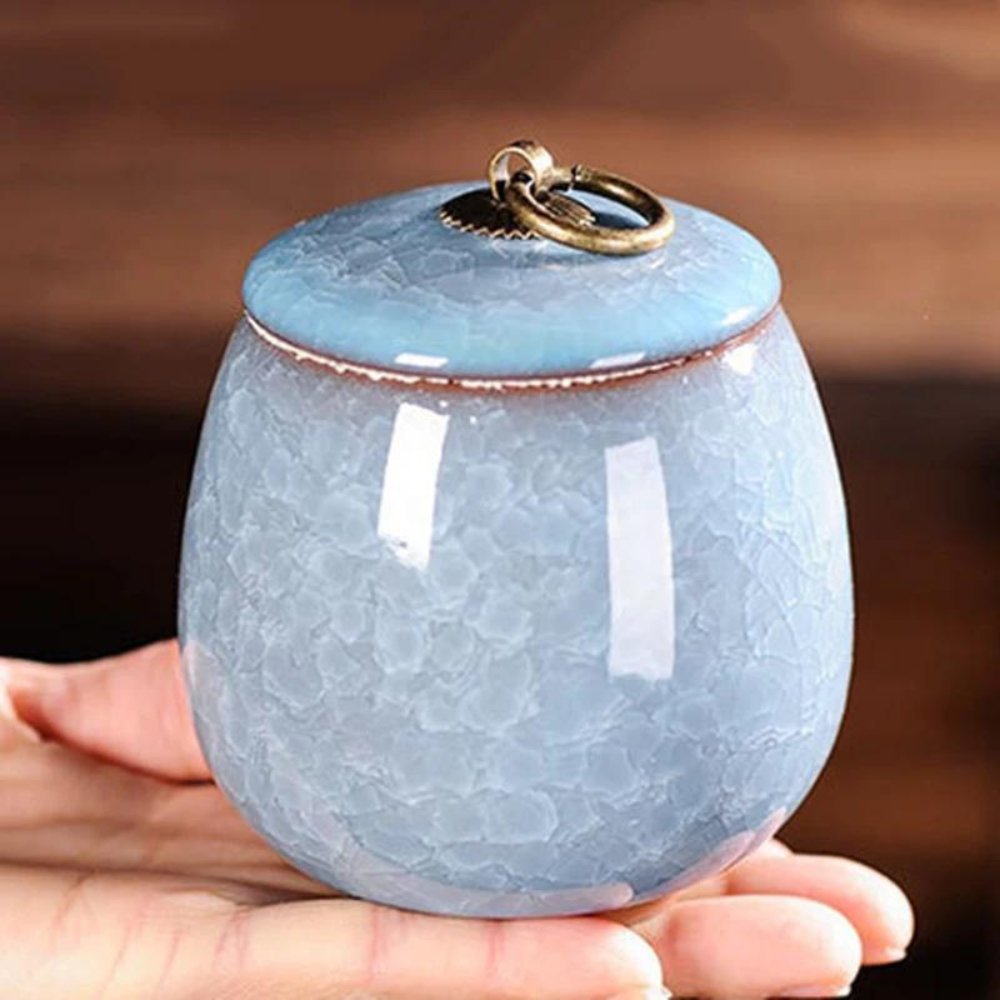 Handcrafted ceramic pet urn with unique craquelé glaze, a loving memorial for pet ashes at home.