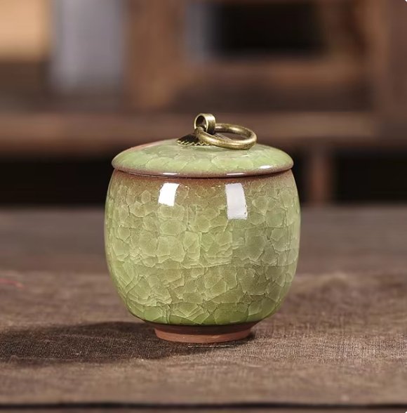 Dignified ceramic urn for pet ashes, features exquisite craquelé glaze and handcrafted detail.