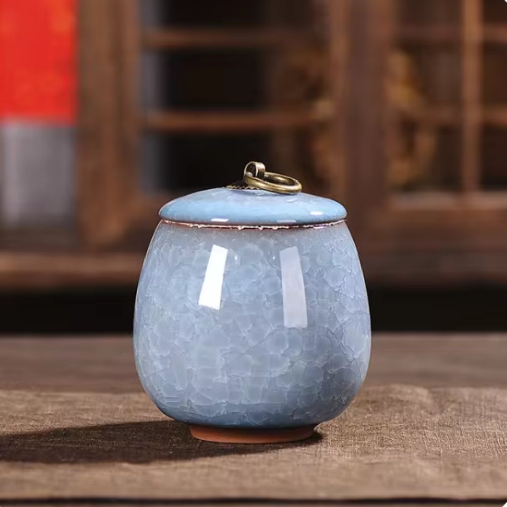 Artisan-crafted ceramic urn with crackle glaze, a dignified tribute for beloved pet's ashes.