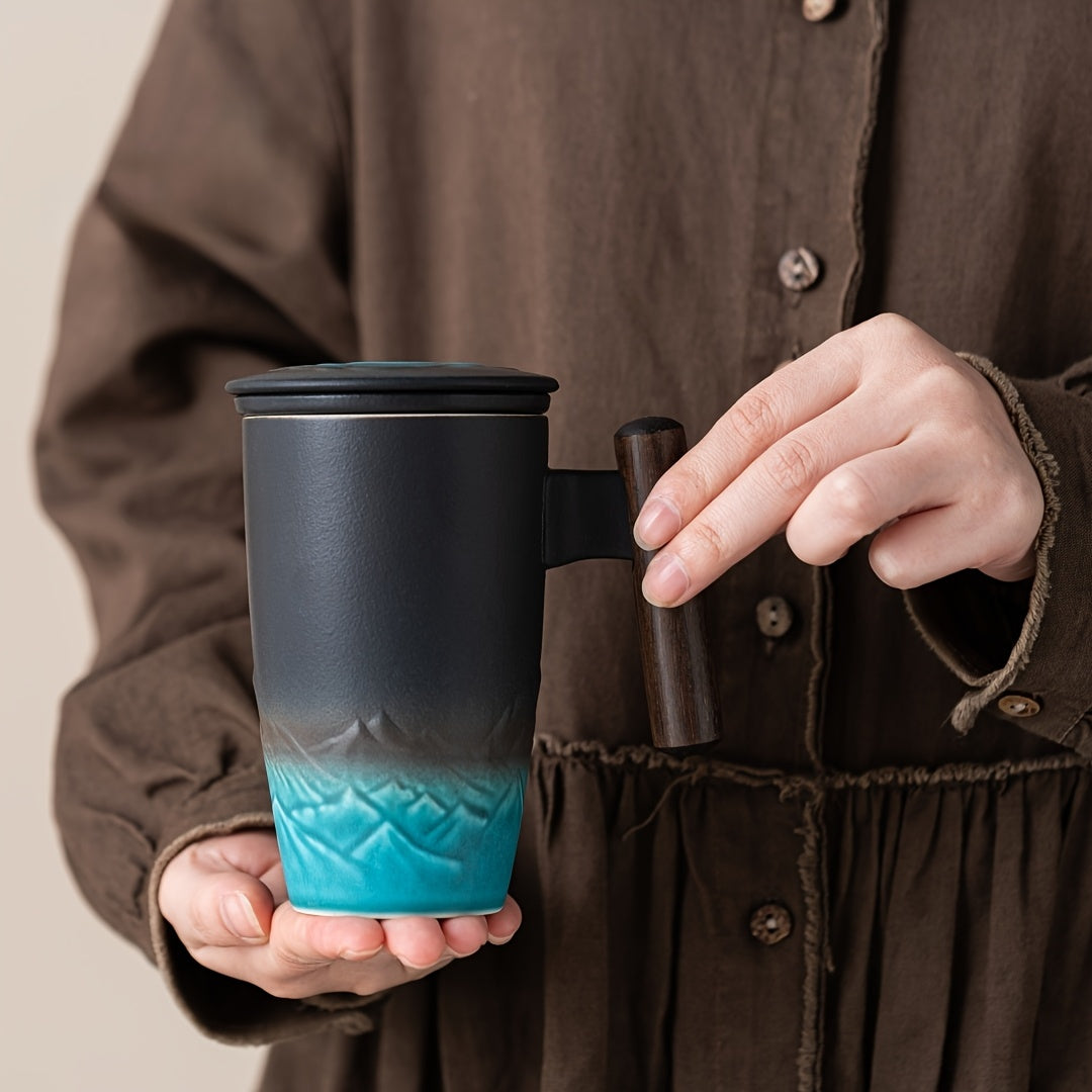 Handcrafted ceramic tea mug with infuser for loose leaf tea, showcasing its unique design and wood handle.