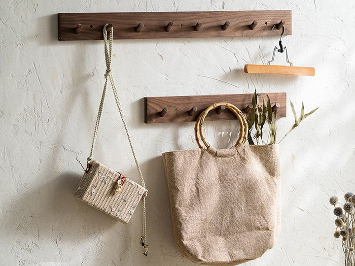 Wall-mounted natural wood coat rack, minimalist Zen decor, perfect for entryway storage.