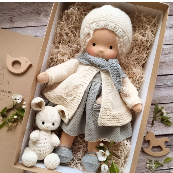 Dressed in a blue smock, this Waldorf doll is ready for adventure.