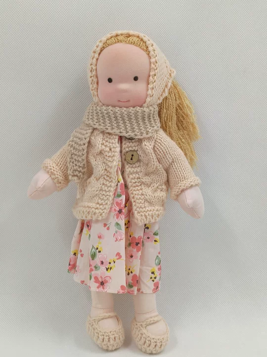 Handmade Waldorf doll with soft, natural features, perfect for imaginative play.