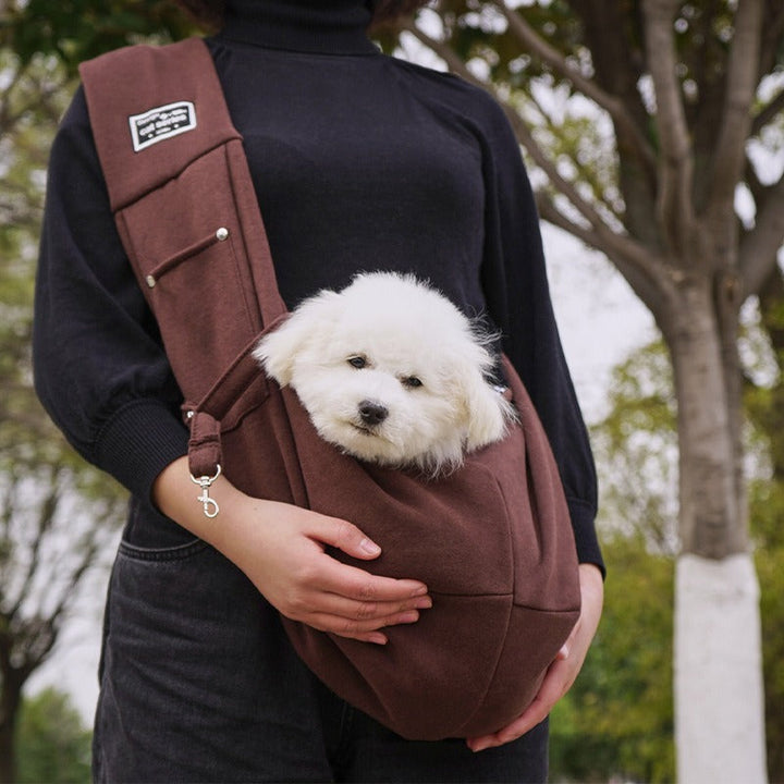 Versatile hands-free dog carrier sling for small to medium pets; reversible, washable, and comfortable travel gear.