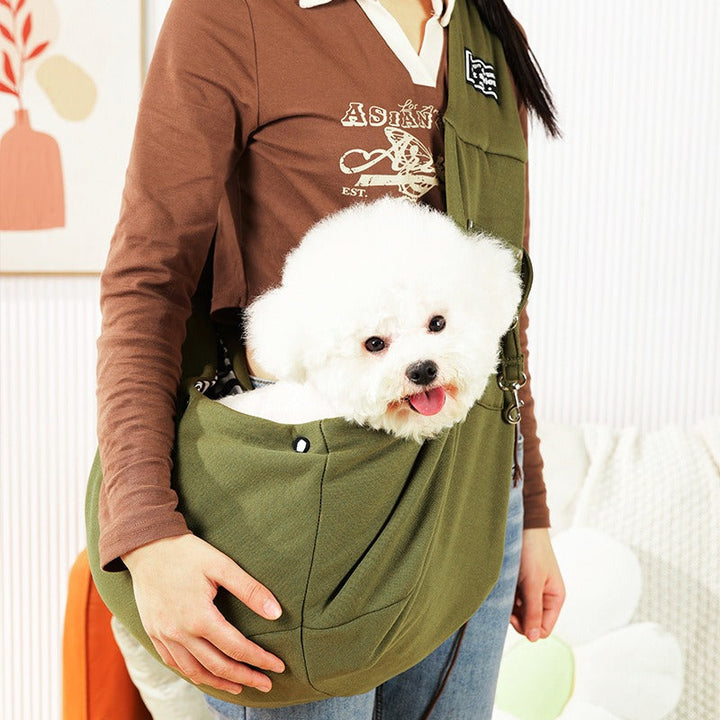 Hands-free dog carrier sling allows easy transport for small to medium pets, a convenient travel accessory.