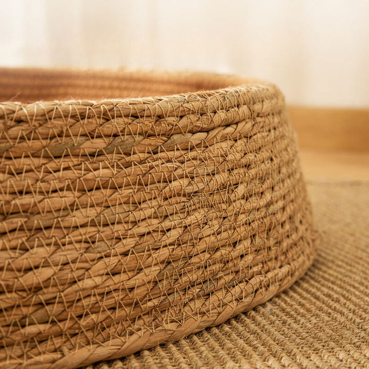 Stylish natural rattan cat scratching bed, providing a cozy and durable resting spot.