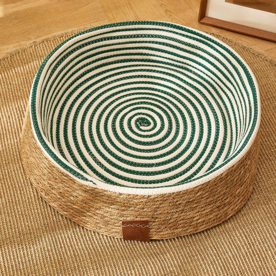 Handmade woven rattan cat bed and scratching post, perfect for indoor cats.