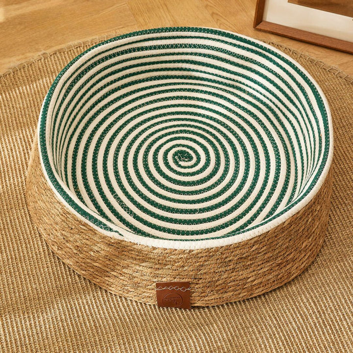 Handmade woven rattan cat bed and scratching post, perfect for indoor cats.
