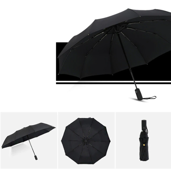 Person holding a heavy duty windproof umbrella, demonstrating its durability in harsh weather.