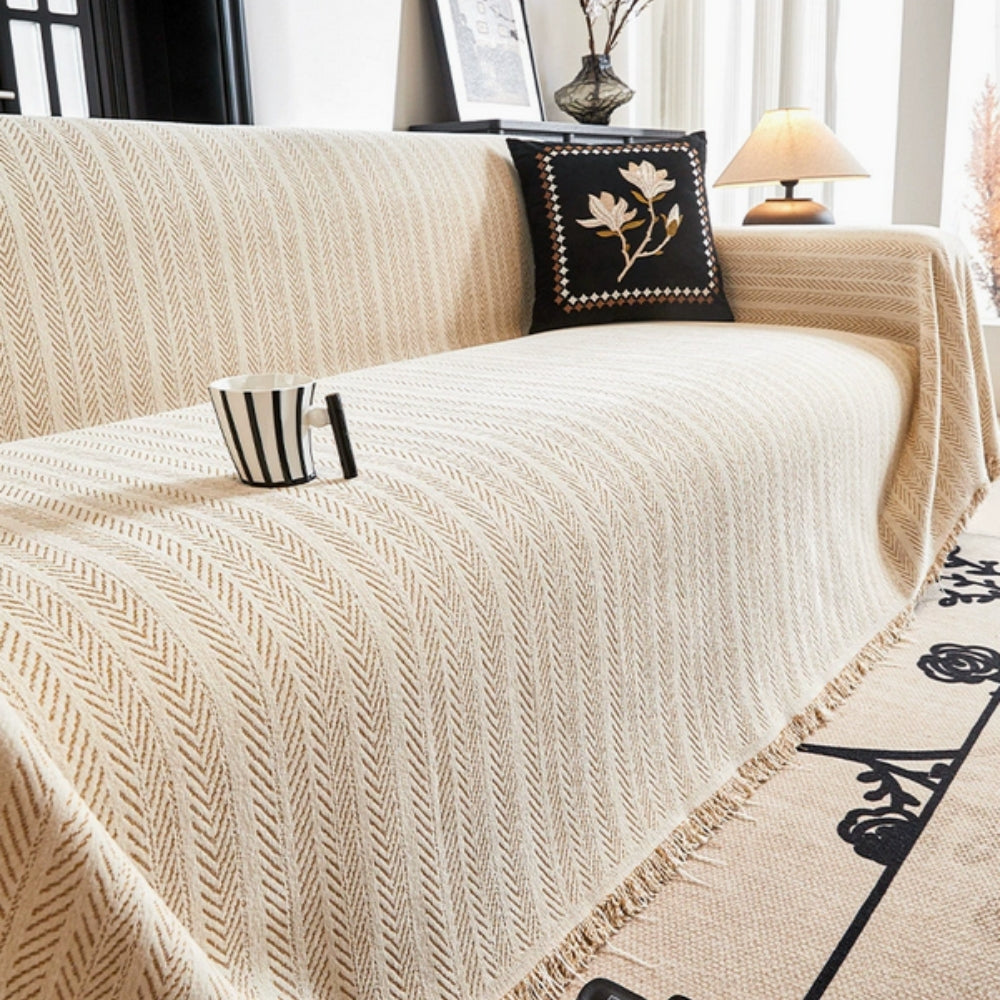 Herringbone chenille sofa cover with elegant tassels, offering furniture protection for living rooms. Pet friendly and anti-slip design.