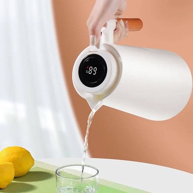 Insulated glass carafe with LED temperature display and natural wood handle for hot and cold beverages.
