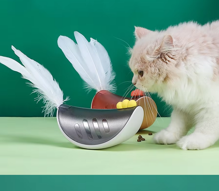 Interactive cat toy with feather and treat dispenser for feline fun and enrichment.