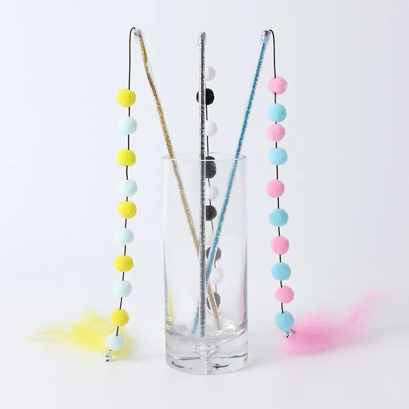 Durable cat wand toy featuring playful feathers & fluffy pompoms, designed for interactive pet play & exercise.