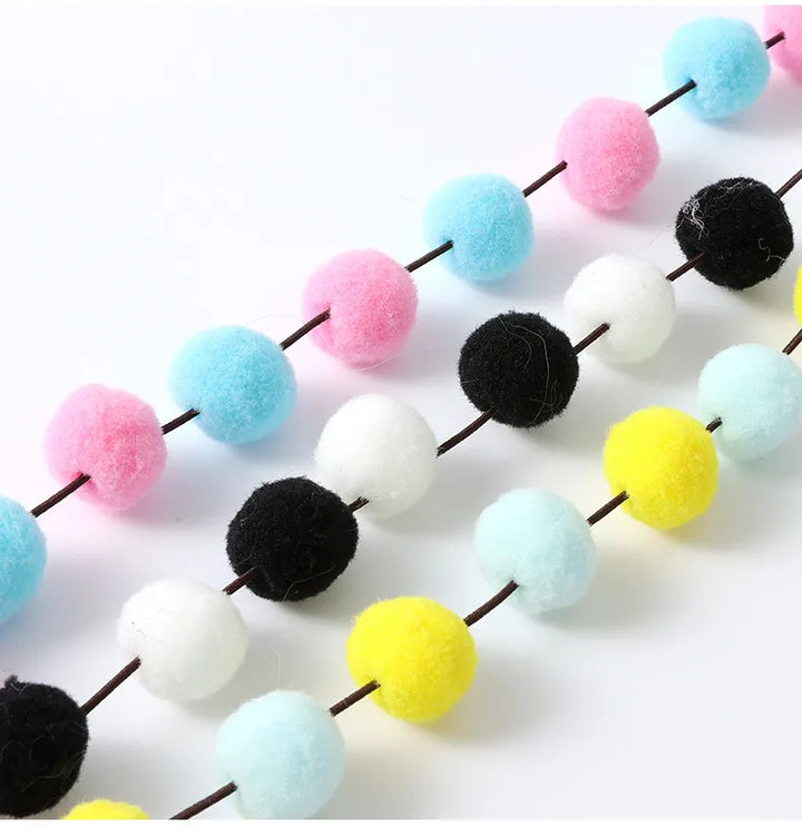 Perfect interactive feather & pompom cat toy wand for energetic kittens, encouraging active play & animal fun.