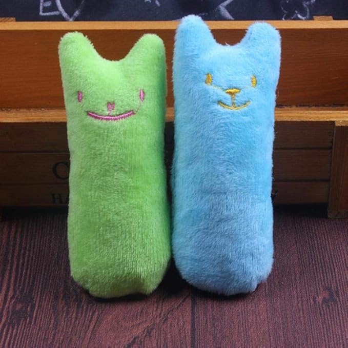 Happy cat playing with an interactive catnip chew toy for fun & stress reduction.