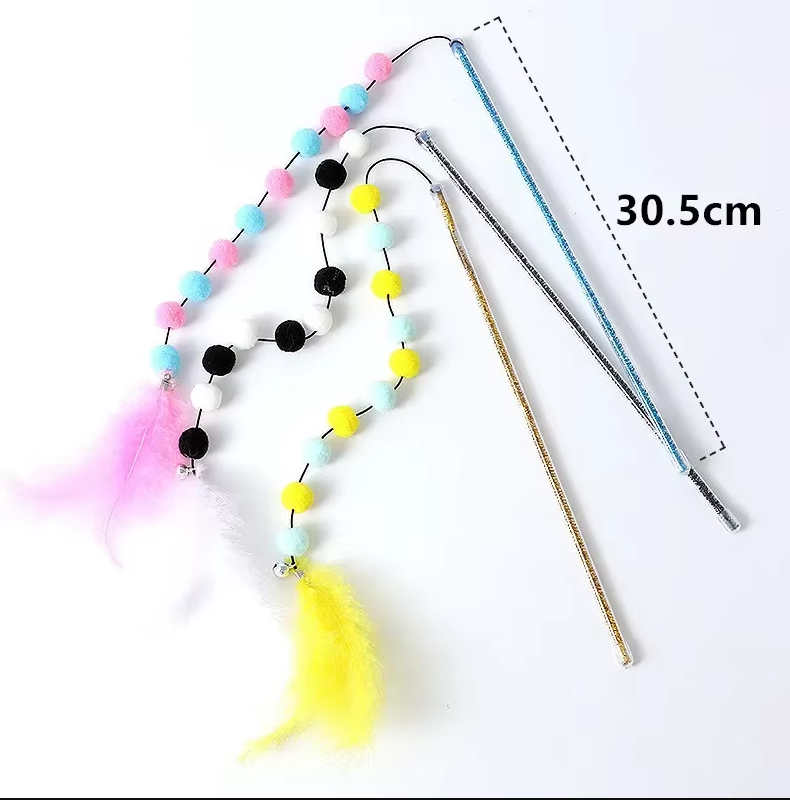 Happy cat playing with interactive fishing rod toy, chasing pom-pom & feathers for engaging feline enrichment.