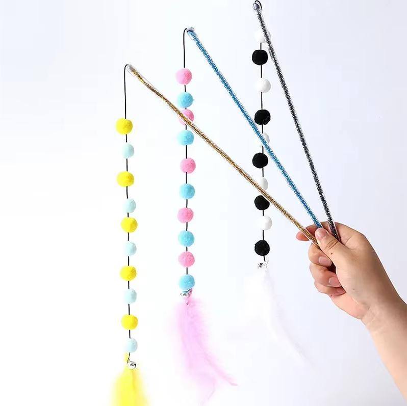 Close-up of an interactive cat fishing rod toy, featuring a vibrant pom-pom and natural feathers for active play.