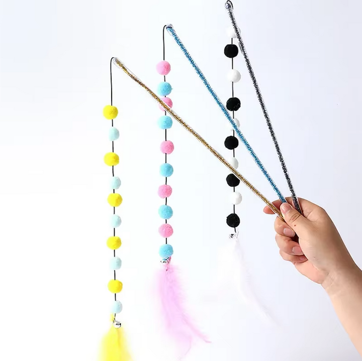 Close-up of an interactive cat fishing rod toy, featuring a vibrant pom-pom and natural feathers for active play.