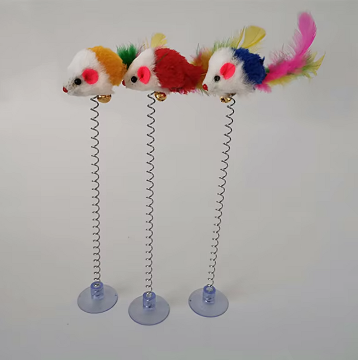 Cat pouncing on a spring-loaded mouse toy with secure suction cup.