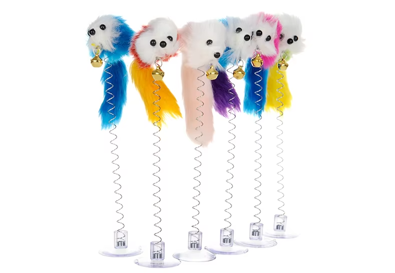 Close-up of a cat batting at the interactive wiggling feather mouse toy, attached to floor with suction cup.