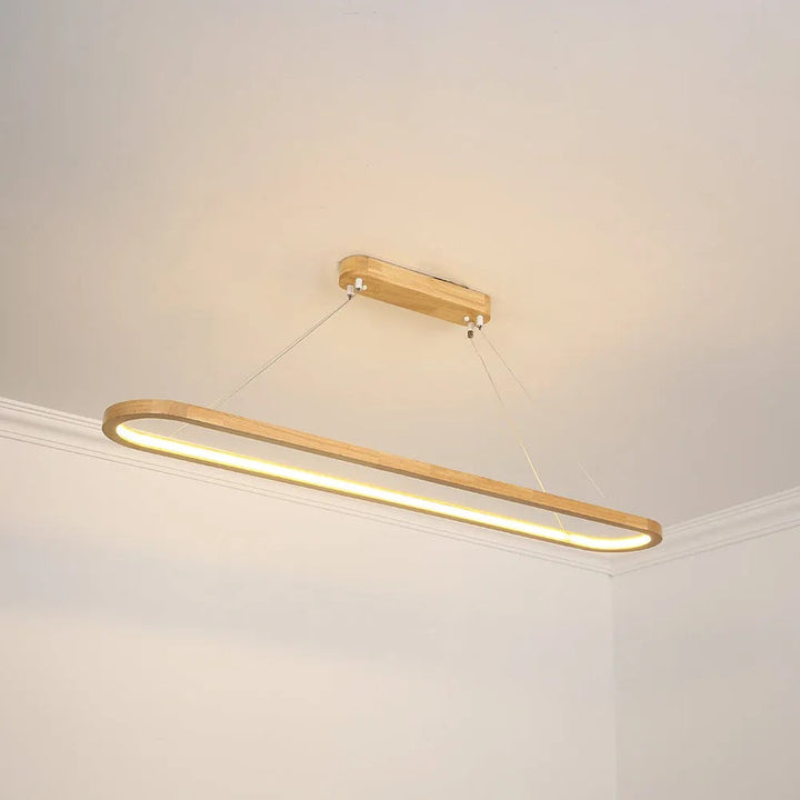Elegant LED oval pendant light for dining rooms, featuring a sleek modern wooden & acrylic frame.