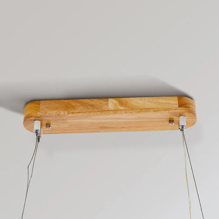 Sleek modern oval pendant light, natural wood & acrylic, perfect LED illumination for kitchen.