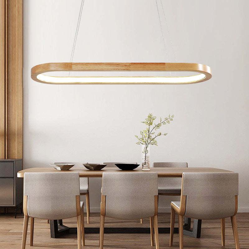 Oval LED pendant light for modern kitchen islands. Wood and acrylic design for contemporary homes.
