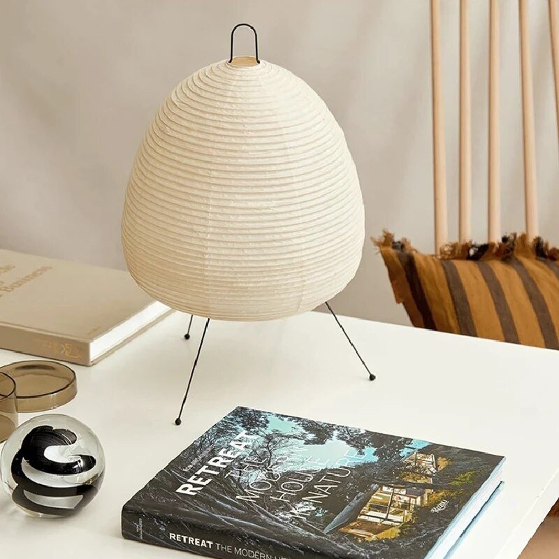 Minimalist Japandi oval LED table lamp. Rice paper shade provides warm accent lighting for modern living room or bedroom decor.