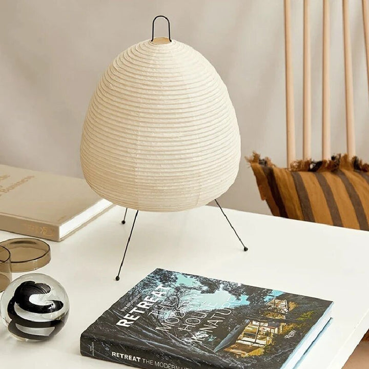 Minimalist Japandi oval LED table lamp. Rice paper shade provides warm accent lighting for modern living room or bedroom decor.