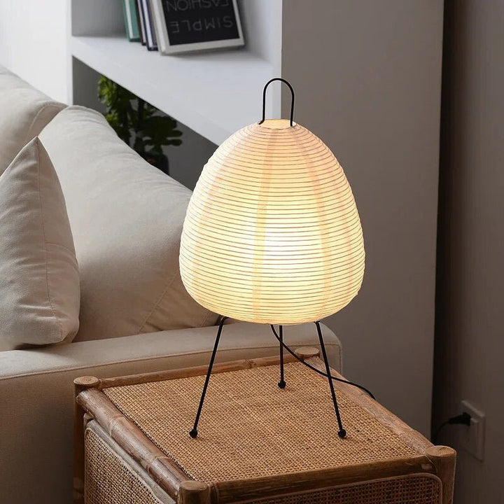 Contemporary oval table lamp with a rice paper shade & integrated LED light. Japandi style for serene bedroom or living room decor.