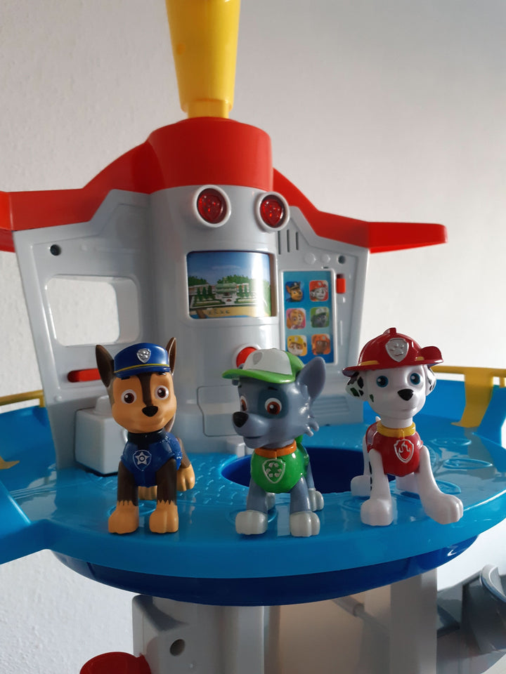 Children's entertainment playset featuring a tall tower and toy cars.
