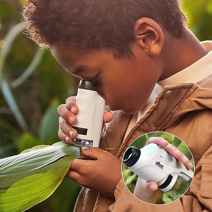 Close-up of a child using a portable kids microscope for educational discovery and early learning science.