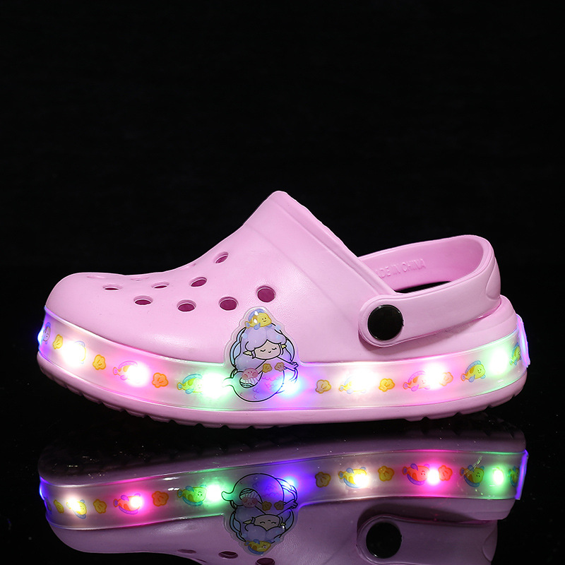 Close-up of breathable kids' clogs featuring a fun glow-in-the-dark design.