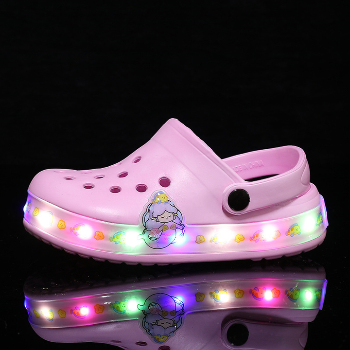 Close-up of breathable kids' clogs featuring a fun glow-in-the-dark design.