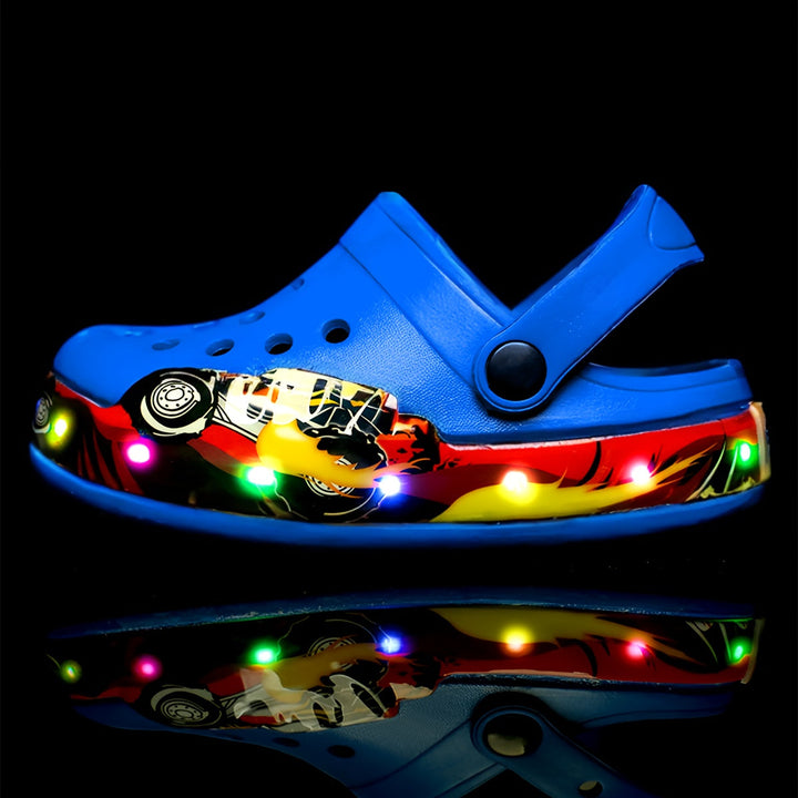 A pair of blue glow-in-the-dark clogs for kids, showing ventilation holes.