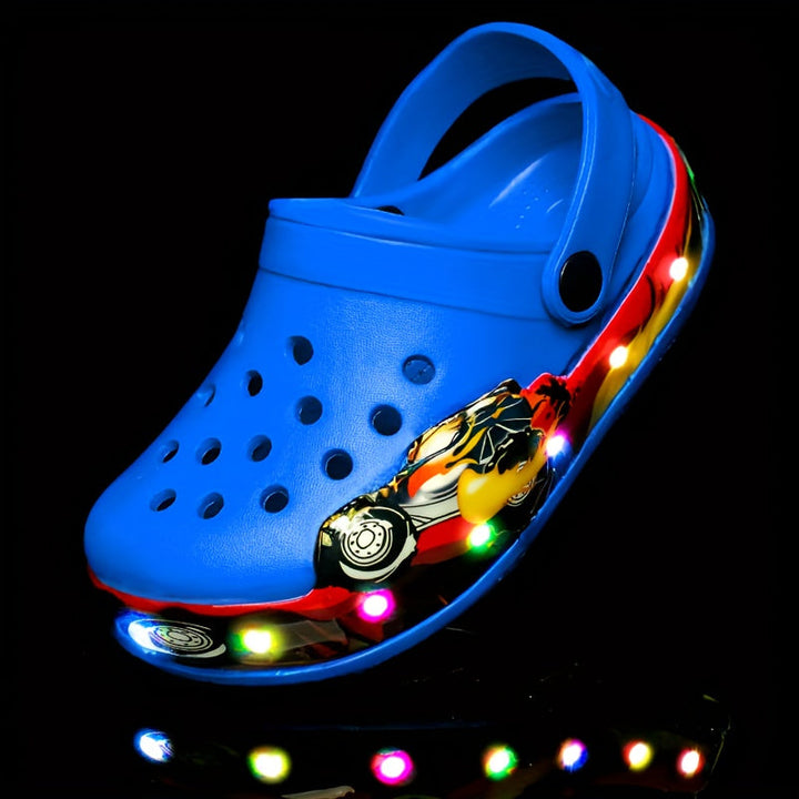 Pink glow-in-the-dark clogs for children, highlighting the anti-slip sole.