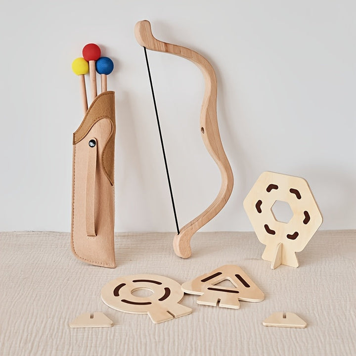 Close-up of a child's hand holding a safe, wooden toy bow from the archery set.